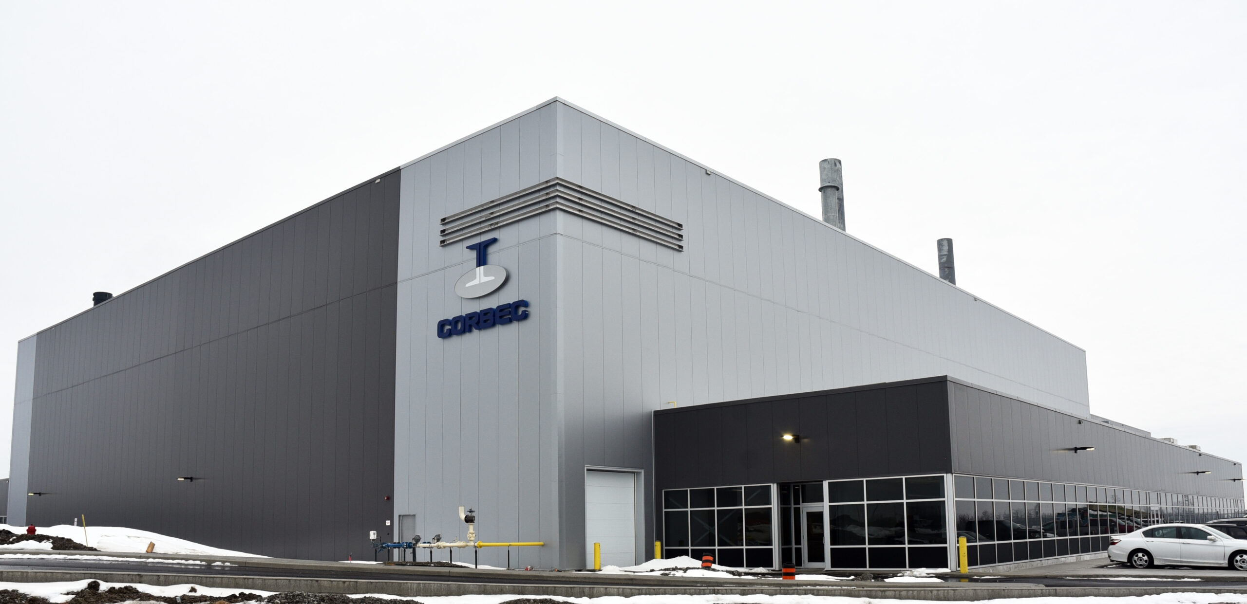 Exterior of the building showing a double-height warehouse space and single-height office on the right-hand side